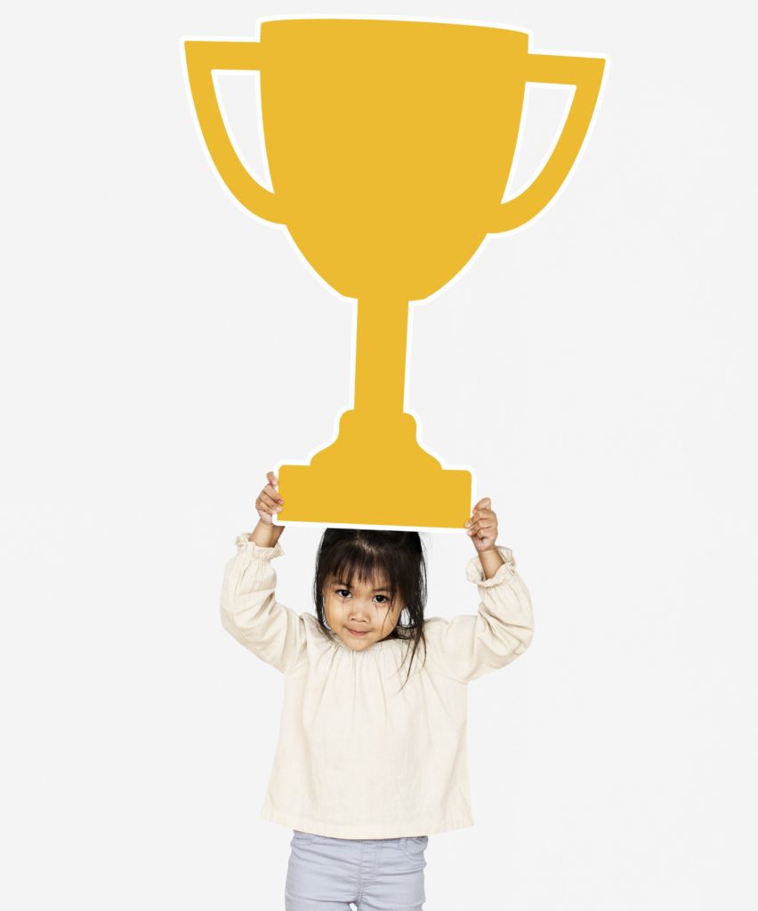 girl celebrating success with a trophy